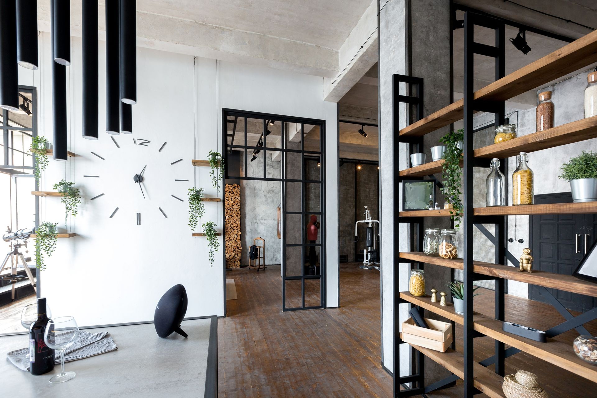 luxury studio apartment with a free layout in a loft style in dark colors. Stylish modern kitchen area with an island, cozy bedroom area with fireplace and personal gym luxury studio apartment with a free layout in a loft style in dark colors. Stylish modern kitchen area with an island, cozy bedroom area with fireplace and personal gym